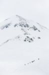 Hikers Climbing A Snow Mountain Stock Photo