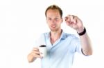 Young Salesman Holding Cup And Coffee Beans Stock Photo