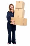 Smiling Woman With Stack Of Cardboard Boxes Stock Photo