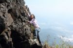 Woman Climbing Rock Stock Photo