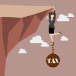 Business Woman Try Hard To Hold On The Cliff With Tax Burden Stock Photo