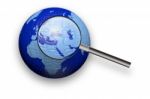 Puzzle Globe And Magnifying Glass Stock Photo