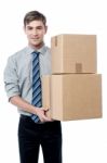 Young Man With With Stack Of Boxes Stock Photo