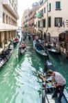 Gondoliers Ferrying Passengers In Venice Stock Photo