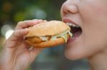Woman Eating A Hamburger Stock Photo