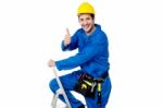 Cheerful Construction Worker On Ladder Stock Photo