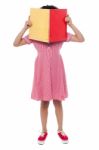 School Girl Hiding Her Face With A Book Stock Photo