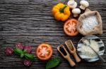 The Ingredients For Homemade Pizza On Shabby Wooden Background Stock Photo