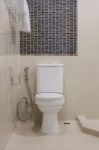 Classic White Toilet Bowl In Bathroom Stock Photo