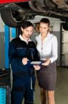 Car Mechanic With Female Customer Stock Photo
