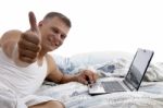 Man With Laptop And Thumbs Up Stock Photo