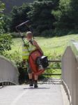 Man Carrying A Lawnmower At Beeston Castle Stock Photo