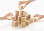 Many Hands Playing Wooden Box On Isolated Background Stock Photo