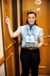 Maid Knocking Door To Deliver Order Stock Photo