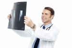 Experienced Orthopedic Surgeon Reviewing X-ray Report Stock Photo