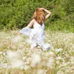 Young Woman In Meadow Stock Photo
