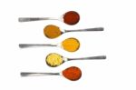 Various Seasoning Spices On Metal Spoons Stock Photo