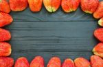 Strawberries Frame On Black Wooden Stock Photo