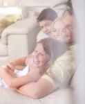 Happy Family Smiling And Looking  Behind The Window Glass Stock Photo