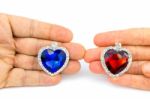 Two Jewelry Hearts On Hand Of Man And Woman Stock Photo