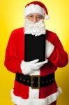 Kris Kringle Presenting New Updated Tablet Pc Stock Photo