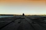 Lone Man On Pier Orange Sunset Stock Photo