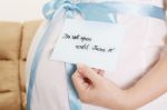 Pregnant Belly With A Light Blue Ribbon And A Tag Saying Do Not Stock Photo