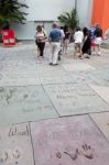 People Looking At The Handprints Footprints And Signatures Of Th Stock Photo