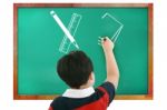 Boy Drawing In Chalkboard Stock Photo