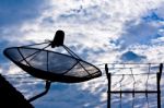 Satellite Dish And Electricity Post In Morning Sky Stock Photo