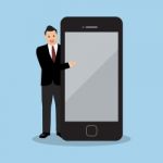 Businessman Pointing To The Screen Of A Smartphone Stock Photo