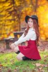 Young Woman With Autumn Leaves In Maple Garden Stock Photo