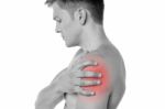 Guy Holding His Shoulder In Pain Stock Photo