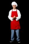 Full Length Portrait Of A Handsome Chef Stock Photo