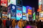 Tourist Walking In Night Shopping Street At Dotonbori In Osaka, Japan Stock Photo
