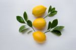 Three Yellow Lemons With Leaf On White Stock Photo