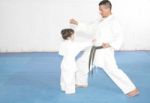 Teacher Training Karate To A Little Girl Stock Photo