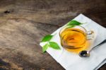 Glass Cup Of Tea And Spoons With Green Leaves Tea Stock Photo