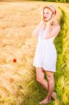 Lonely Beautiful Young Blonde Girl In White Dress With Straw Hat Stock Photo