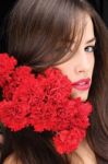 Woman And Red Carnations Stock Photo