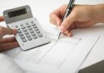 Bookkeeping With Calculator Stock Photo