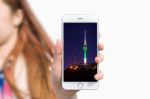 Hand Holding Smart Phone With Photo Of Seoul Tower Isolated On White Background Stock Photo