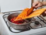 Woman Cooks Carrots And Beets Stock Photo