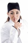 Beautiful Chef Shushing With Finger Stock Photo