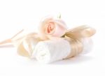 Rose With Decorative Ribbons Over Rolled Up Bath Towels Stock Photo