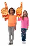 Little Girls Raises Arms With Foam Finger Stock Photo