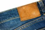 Jeans With Brown Leather Label On White Stock Photo