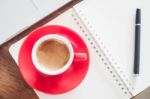 Red Coffee Cup With Notepad And Laptop Stock Photo