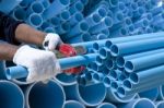 Worker Cutting Pvc Pipe Stock Photo