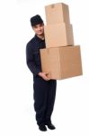 Young Courier Guy Moving Boxes Stock Photo